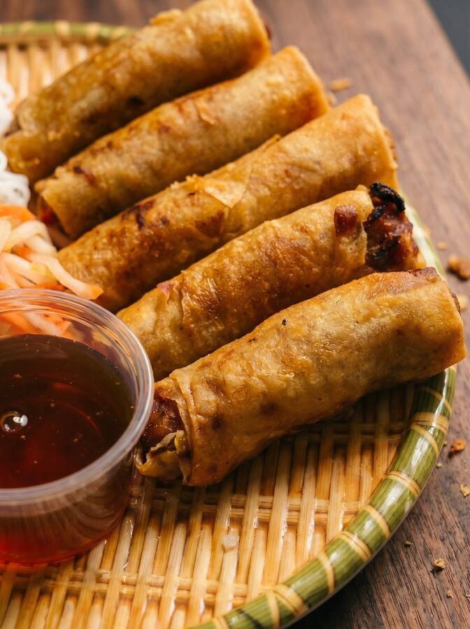 Plate of hand-rolled crispy spring rolls